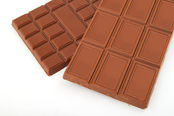 different sorts of chocolate in a stack on white background
