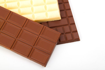 different sorts of chocolate in a stack on white background