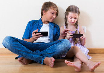 Children playing in mobile phones