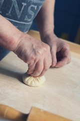 Female hands making hinkali close up