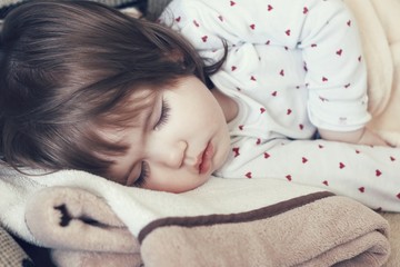 Small child peacefully sleeps close up