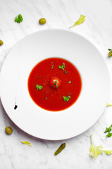 Tomato soup in a bowl on a marble on top