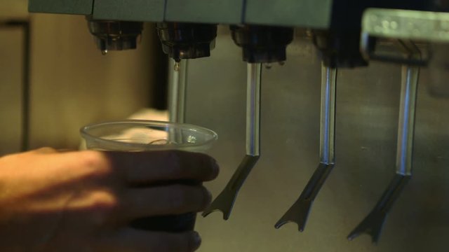 Soft drink dispensing from a soda fountain dispenser popular in fast food or self serve restaurants and cafeterias.
