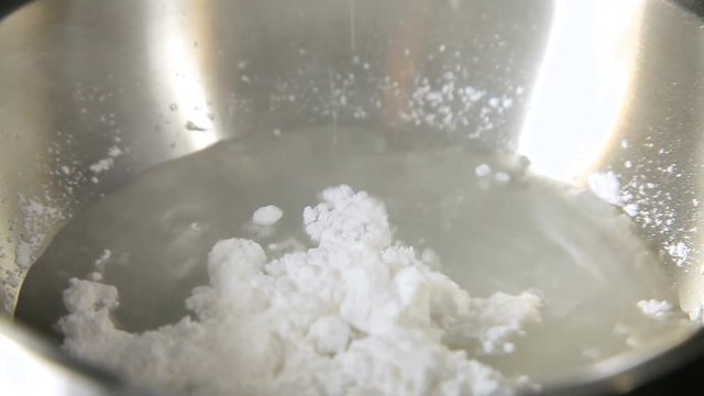 the powder pours into the water