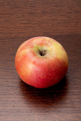 red apple on top of a wooden table