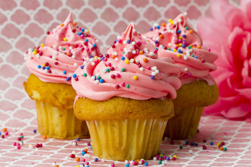 close-up shot of a strawberry cupcake with sprinkles.