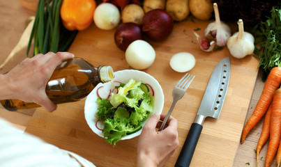 Young woman cutting vegetables in the kitchen
