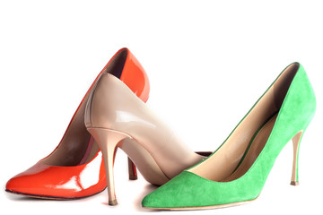bright, multicolored female shoes on high heels isolated on white background