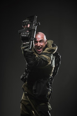 Fototapeta na wymiar soldier man hold Machine gun on a dark background