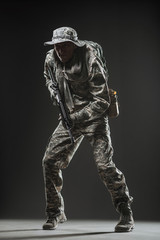 Fototapeta na wymiar Special forces soldier man with Machine gun on a dark background