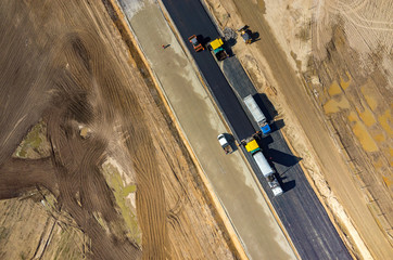 Road rollers working on the construction site aerial view
