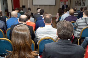 The audience listens to the acting in a conference hall