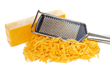 grated bar of cheddar cheese and metal grater