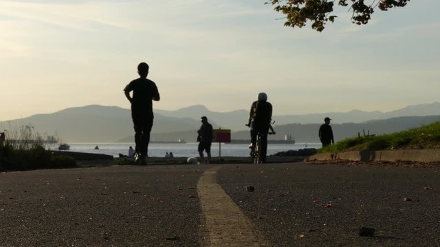 Silhouettes bicycles ocean mountains Vancouver