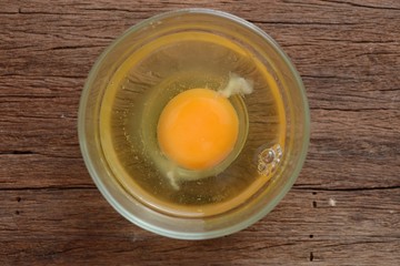 Top view of fresh raw eggs in a glass bowl 