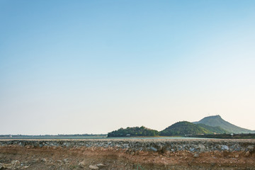 The curb erosion from storms. To indicate the layers of soil and rock.