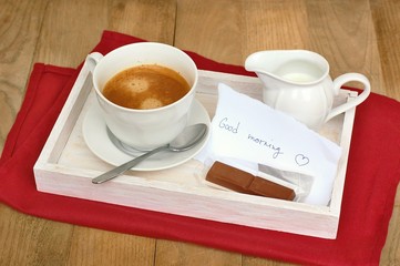 Espresso in the cup with milk and chocolate