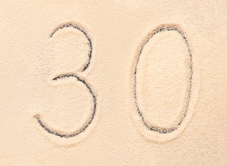 30 number written on beach sand