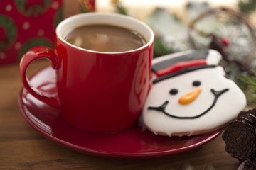 cup of brown coffee with christmas cookie