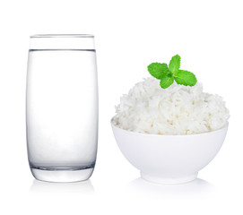 Glass of water and rice in bowl isolated white background