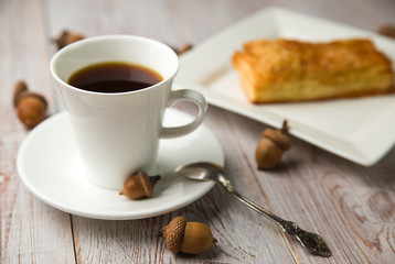 Cup of coffee, sweet buns and acorns