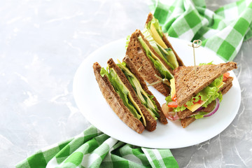 Tasty and fresh sandwiches on a grey table