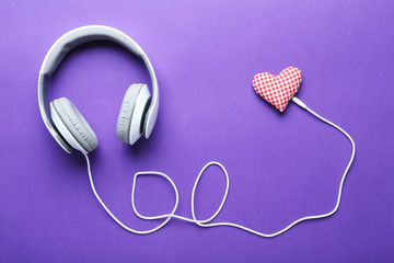 Headphones on a purple paper background, close up