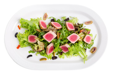 Grilled tuna fillet on fresh salad mix.
