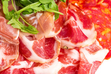 Obraz premium Delicious italian dried meat with arugula.