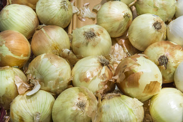 yellow onions crop from market shelves real with flaws and bruis