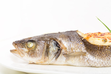 Baked sea bass with seafood and cheese.