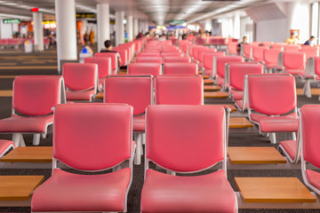 Airport terminal; waiting area for departure near window.