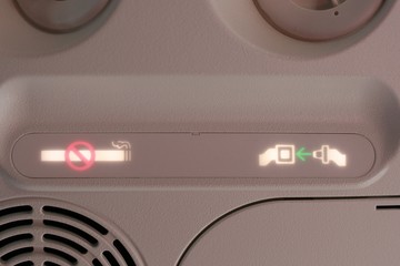 No smoking and seatbelt fasten sign on the airplane