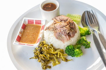 Stewed pork leg on rice isolated on white background, asian food