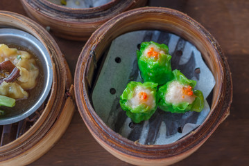 Chinese steamed pork dumplings in bamboo steamers, Asian dish.