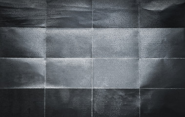 Background pattern of folded black paper in 16 parts