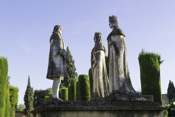 Statues of the Catholic Monarchs (Ferdinand and Isabella) and Christopher Columbus in the gardens of the Alcazar in Cordoba, Spain - obrazy, fototapety, plakaty