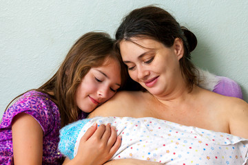 Obraz na płótnie Canvas Mother And Daughter Adore Newborn