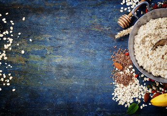 Obraz na płótnie Canvas Bowl of oatmeal porridge with healthy ingredients
