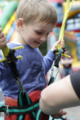 Child wears outfit for jumping on a trampoline