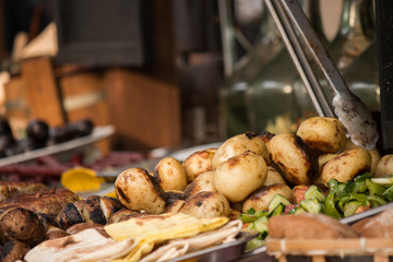 grilled potatoes on counter in food court 