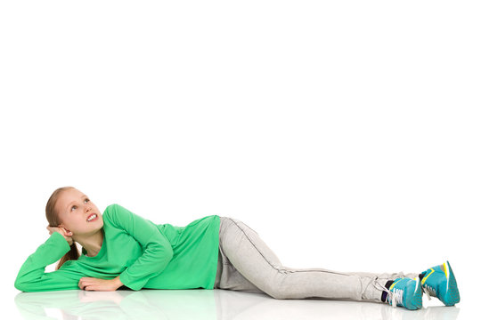 Young Girl Lying On A Floor And Looking Up