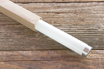 Fluorescent neon light white tube on wooden background
