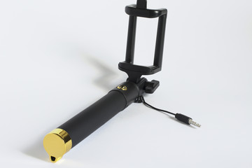 Wired selfie stick on a white background