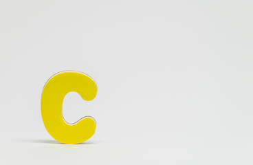 Yellow wooden alphabet C with white background and selective focus