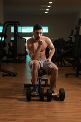 Obraz na płótnie Canvas Portrait Of A Handsome Man Resting At Gym