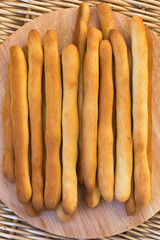 fresh breadsticks on a cutting board