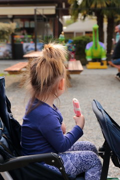 bambina che mangia il gelato al parco giochi