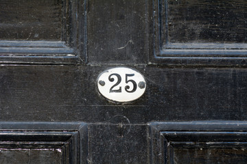 House number 25 sign on door