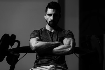 Fototapeta na wymiar Portrait Of A Young Muscular Athletic Man Posing While Sitting A